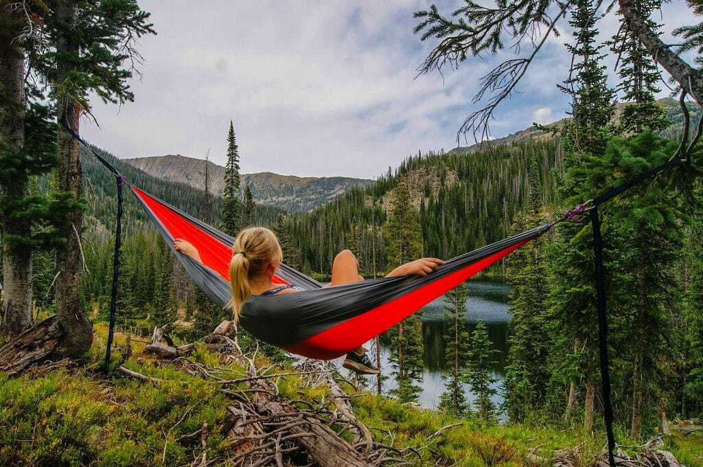 sitting in a hammock in the mountains