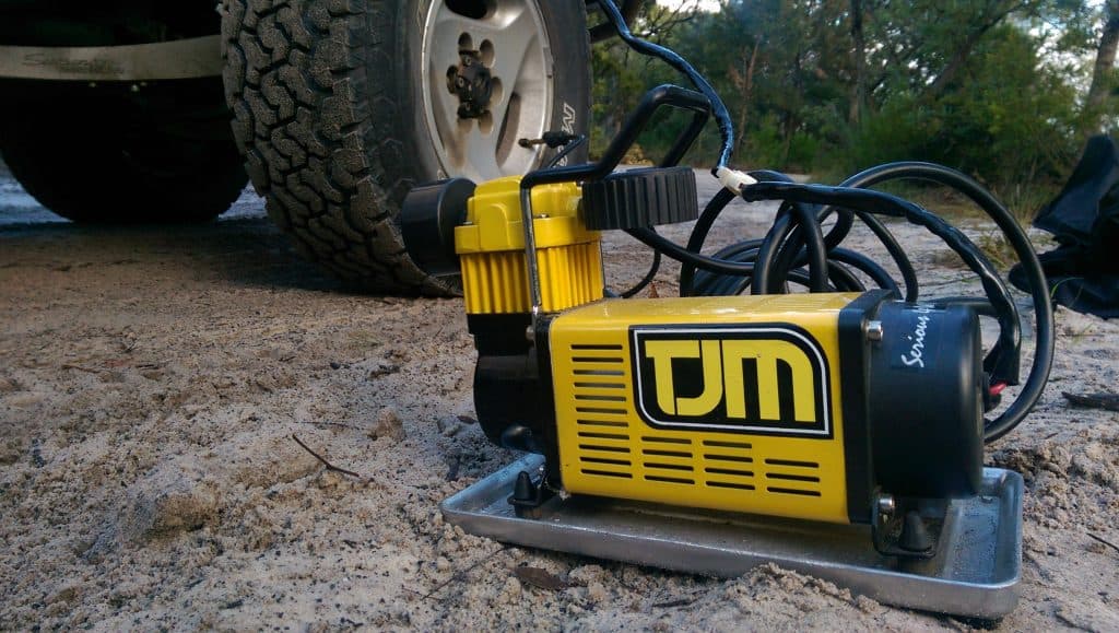 3. Portable air compressor inflating a tire.